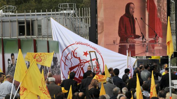 Supporters listen to Maryam Radjavi (on screen), president of the NCRI and Mujahedeen-e-Khalq (MEK) leader (AFP)