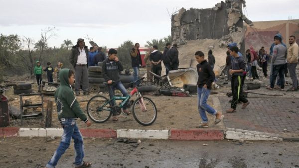 Palestinians stand next to the remains of a building, that was destroyed following an Israeli air strike, in Khan Yunis in the southern Gaza Strip on November 12, 2018. (SAID KHATIB / AFP)