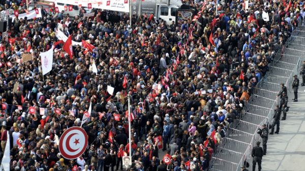 Tunisian protesters wave national flags .(FETHI BELAID / AFP)