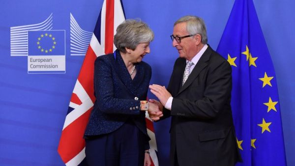 EU Commission President Jean-Claude Juncker shakes hands with Britain's Prime Minister Theresa May as she arrives for Brexit talks at the EU Headquarters in Brussels on November 24, 2018. (AFP)