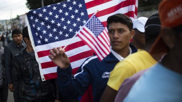 Central American migrants -mostly Hondurans- wanting to reach the United States in hope of a better life, queue for food outside a shelter in Tijuana, Baja California State, Mexico. (AFP)