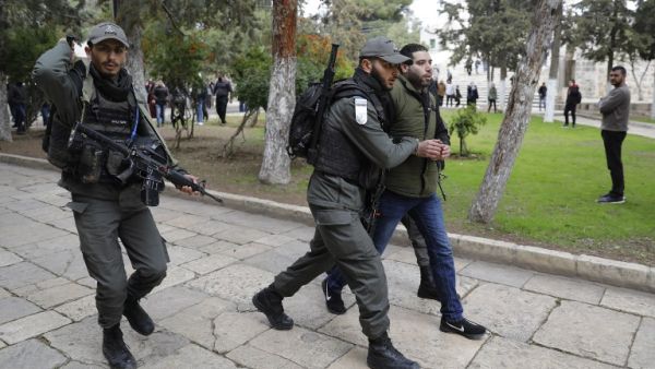 Israeli policemen detain a Palestinian demonstrator during clashes, after protesters tried to break the lock on a gate at the Al Aqsa mosque. (AFP/ File)