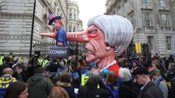 A puppet head of Britain's Prime Minister Theresa May spearing a representation of the British Economy is positioned on Whitehall outside Downing Street. (AFP/ File)
