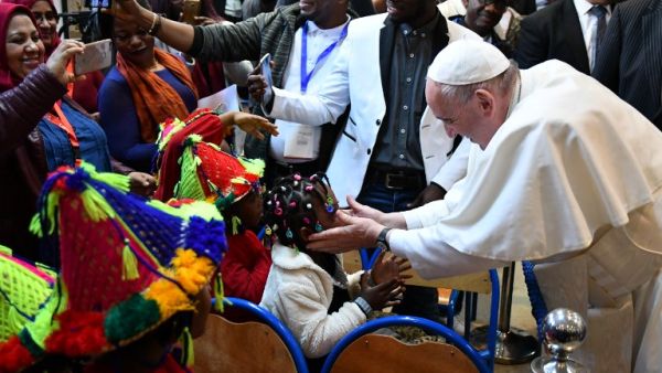 Pope Francis greets children during his visit to a centre run by the Catholic humanitarian organisation Caritas, which hosts migrants, in the Moroccan capital Rabat. (AFP/ File)