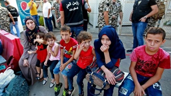 Syrian refugees gather as they prepare to leave the Lebanese capital Beirut, before their journey to return home to Syria. (AFP)