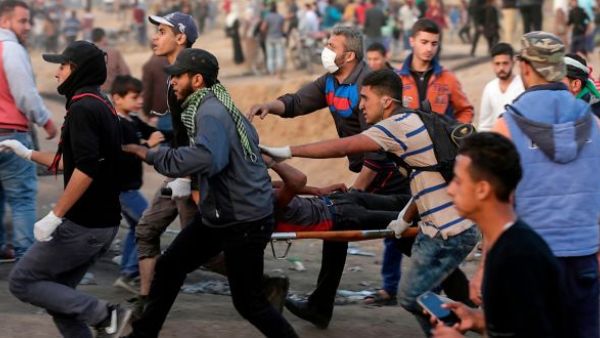 Palestinians evacuate an injured protestor during clashes near the Israeli border fence in Gaza.(AFP/ File Photo)