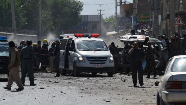 Afghan security forces inspect the site of a suicide attack near Kabul airport. (AFP Photo/Shah Marai)