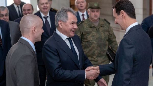 Syrian President Bashar al-Assad greeting the visiting Russian defence minister, Sergei Shoigu, in Damascus on March 19, 2019. (AFP /STRINGER)
