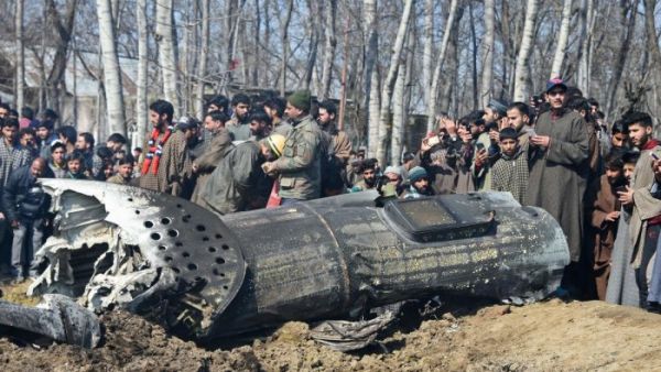Soldiers and Kashmiri onlookers stand near the remains of an Indian Air Force aircraft after it crashed in Budgam district on the outskirts of Srinagar on Wednesday February 27th. (AFP/ File)