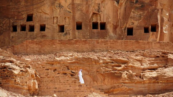 A Saudi man walking near ancient tombs at the Khuraiba archaeological site near Saudi Arabia’s northwestern town of al-Ula. (AFP)