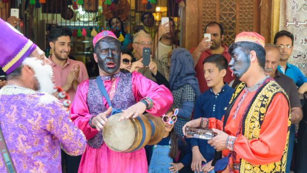 Dancers musicians with black face dance in the street in Bazaar to spread good cheer in Nowruz holidays in Iran. (Shutterstock/ File Photo)
