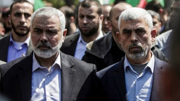 Yahya Sinwar (R) the new leader of Hamas in the Gaza Strip and senior Hamas official Ismail Haniyeh attend the funeral of Hamas official Mazen Faqha in Gaza. (AFP/File)