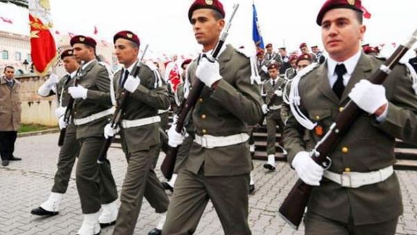 Tunisian troops takes part in an official ceremony marking the third anniversary of the uprising that ousted long-time dictator Zine El Abidine Ben Ali on Tuesday in Tunis. [AFP]