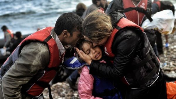 Syrian family becomes emotional after surviving the treacherous crossing between Turkey and Greece. (AFP/File) Syrian family becomes emotional after surviving the treacherous crossing between Turkey and Greece. (AFP/File)