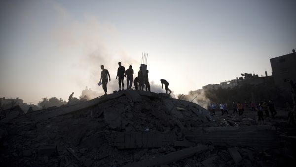 Palestinians inspect a damaged building after an Israeli military strike in Gaza City. (AFP/File)