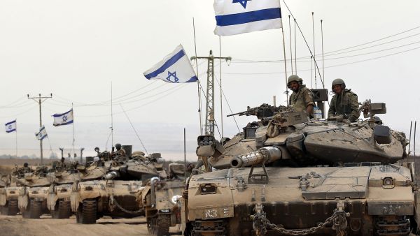 Israeli Merkava tanks drive near the border between Israel and the Gaza Strip as they return from the Hamas-controlled Palestinian coastal enclave on August 5, 2014. (AFP/File)