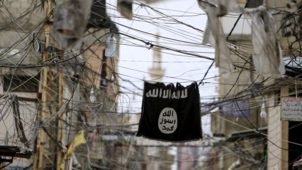An ISIS flag hangs among electric wires over a street in Ain al-Hilweh Palestinian refugee camp, outside the port city of Sidon in southern Lebanon. (AFP/File)