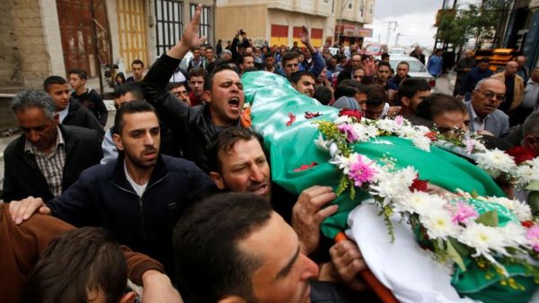 Relatives and friends chant slogans during the funeral of Abdul Fatah al-Sharif in Hebron. (AFP/File)