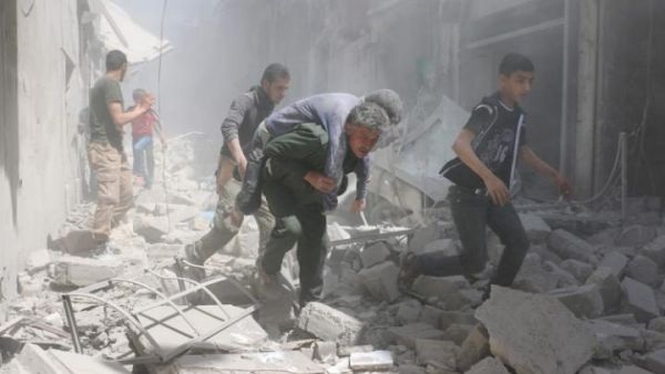 An injured man is evacuated from the aftermath of an air strike in the al-Qatarji area of Aleppo on Friday. (AFP/Ameer Alhalbi) 
