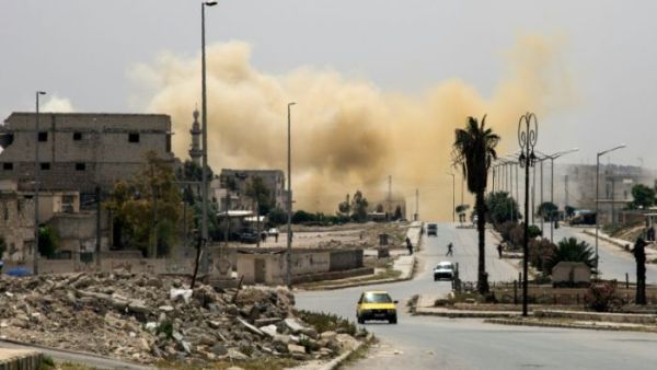 Smoke rises on a main road in the Salaheddin neighbourhood of Aleppo following a reported air strike on April 24, 2016. (AFP/File)