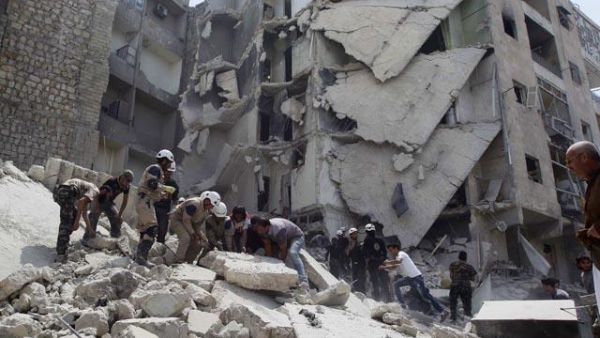 Amid claims of barrel bombs and cluster munitions being used, the French and British foreign ministers are denouncing 'war crimes'. (AFP/File)