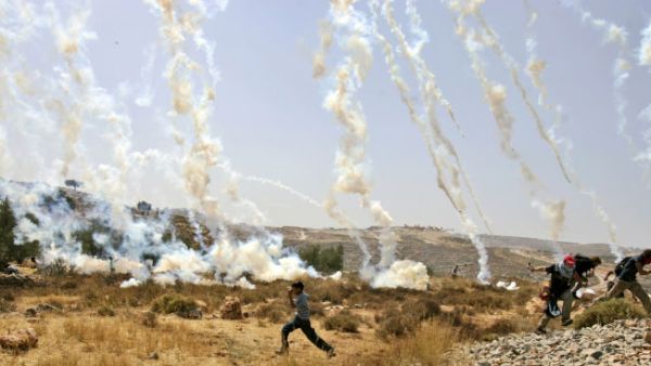 Tear gas canisters rain down on demonstrators in the West Bank village of Bilin. (AFP/File)