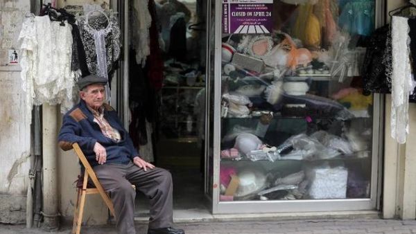 A Lebanese-Armenian man sits next to his shop in the Burj Hammoud area of Beirut. (AFP/File)
