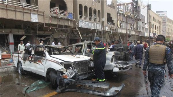 Rescue teams and security forces inspect the site of a car bomb blast in Baghdad's centre. (AFP/File)