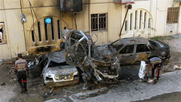 People inspect the wreckages of burnt cars on May 1, 2015. (AFP/File)