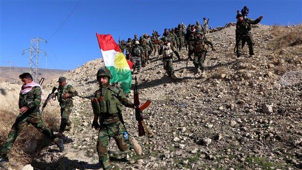 Iraqi Kurdish Peshmerga forces and fighters from the Izadi community hold a Kurdish flag while entering the northern Iraqi town of Sinjar, in the Nineveh Province, November 13, 2015. (Twitter)