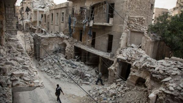 A Syrian man walks past destroyed buildings on May 2, 2016, in Aleppo. (AFP/File)