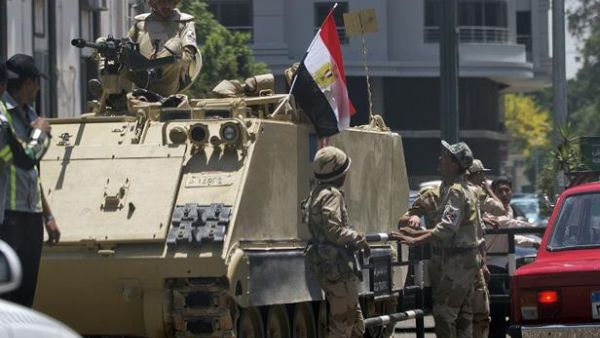 Egyptian soldiers stand next to an armored personnel carrier on the road leading to Cairo University on July 4, 2013 in Cairo. (AFP/Gianluigi Guercia)