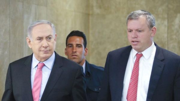 PM Benjamin Netanyahu is accompanied by PMO Director-General Eli Groner to weekly cabinet meeting. (AFP/File)