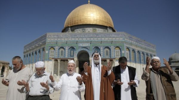 Palestinians from Gaza pray outside the Dome of the Rock during their visit to the Al-Aqsa mosque. (AFP/File)