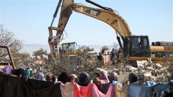 The file photo of an Israeli army bulldozer demolishing a Palestinian home in the West Bank. (AFP/File)