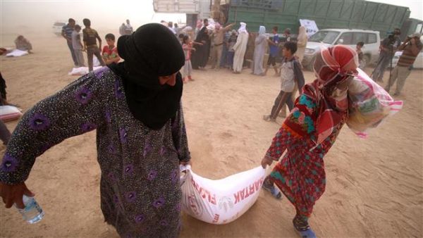 Displaced Iraqis, who fled the western city of Fallujah, carry bags of food donated by a non-government organization called Preemptive Love Coalition at a makeshift camp housing Internally Displaced Persons (IDPs) in the city of al-Khalidiyah. (AFP/File) Displaced Iraqis, who fled the western city of Fallujah, carry bags of food donated by a non-government organization called Preemptive Love Coalition at a makeshift camp housing Internally Displaced Persons (IDPs) in the city of al-Khalidiyah. (AFP/File)