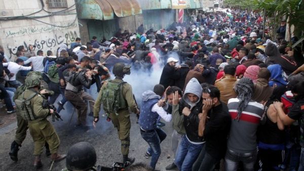 Israeli security forces fire tear gas canisters to disperse Palestinian protesters during a demonstration. (AFP/File)
