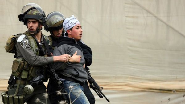 Israeli border police detain a Palestinian demonstrator following clashes at the entrance of the Jalama checkpoint. (AFP/File)
