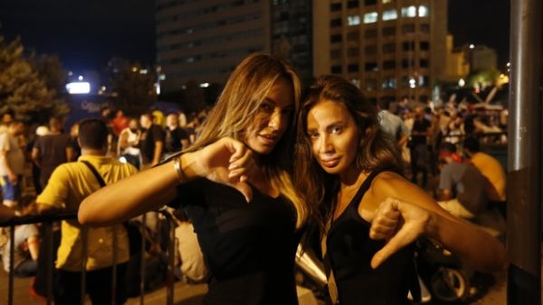 Lebanese protesters gesture during a demonstration organized by the "You Stink" campaign against the ongoing trash crisis in the capital Beirut on 22 August. (AFP/File)