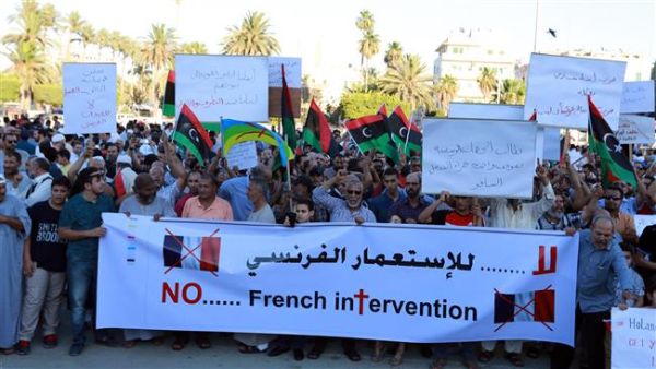 Libyan protesters hold banners and placards during a demonstration in the capital, Tripoli, to protest the French military intervention in the North African country, July 20, 2016. (AFP/File)