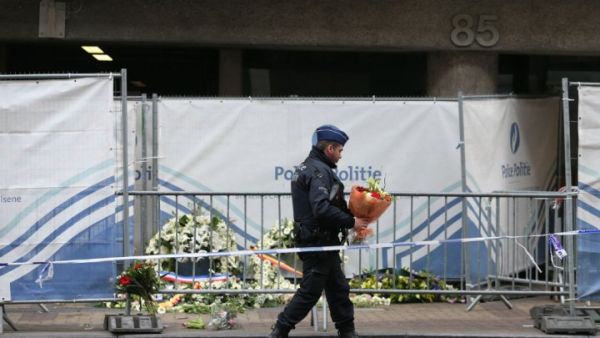 A security official lays flowers at the memorial site at Maalbek metro station. (AFP/File)