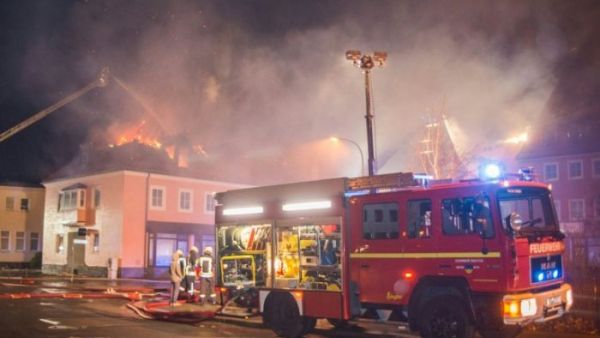 Fire fighters try to extinguish a fire at a former hotel that was under reconstruction to become a home for asylum seekers on February 21, 2016 in Bautzen east of Dresden, eastern Germany. (AFP/Rico Loeb)