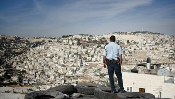 A Palestinian looks towards the sprawling illegal Israeli settlements of East Jerusalem. (AFP/File)
