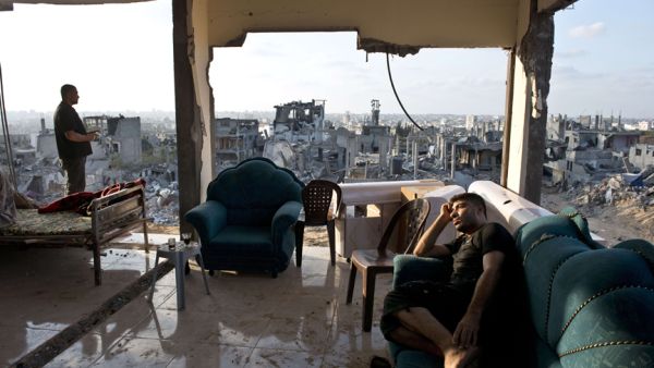 Palestinians from Gaza sit amidst the aftermath and rubble of Israeli airstrikes. (AFP/Roberto Schmidt)