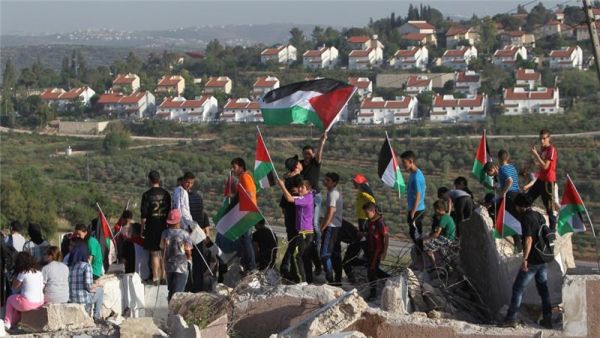 Palestinians hold a protest beside illegal Israeli settlements. (AFP/File)