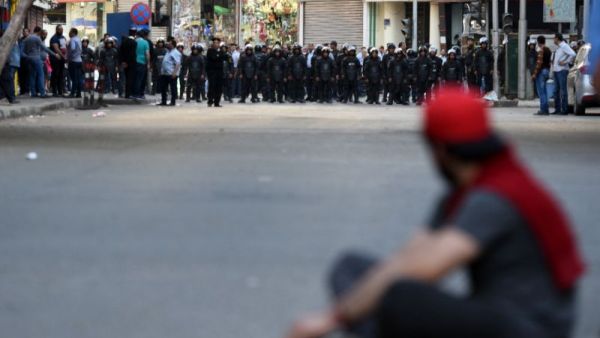 A protester sits in front of riot policemen during a demonstration on April 15, 2016 in central Cairo against a controversial deal to hand two islands in the Red Sea to Saudi Arabia. (AFP/Mohamed El-Shahed) A protester sits in front of riot policemen during a demonstration on April 15, 2016 in central Cairo against a controversial deal to hand two islands in the Red Sea to Saudi Arabia. (AFP/Mohamed El-Shahed)
