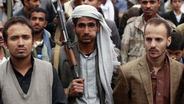 A supporter of the Shia Houthi movement chews Qat, a mild drug used daily by most Yemenis, as he carries a rifle during a demonstration against the Saudi-led air strikes, in the capital Sanaa, on May 8, 2015. (AFP/Mohammed Huwais)