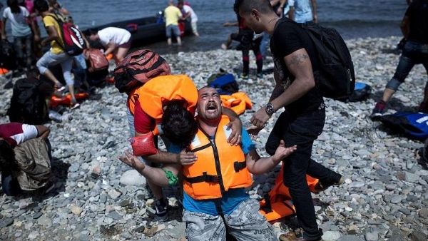 A refugee from Syria prays after arriving on the shores of the Greek island of Lesbos aboard an inflatable dinghy from Turkey. (AFP/File)