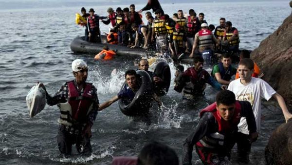 Refugees disembark from lethal dinghy boats after crossing. (AFP/File)