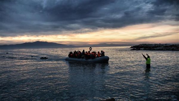 This photo taken on February 17, 2016 shows refugees massed onto an inflatable boat reaching Mytilene, northern Greek island of Lesbos, after crossing the Aegean sea from Turkey. (AFP/File)